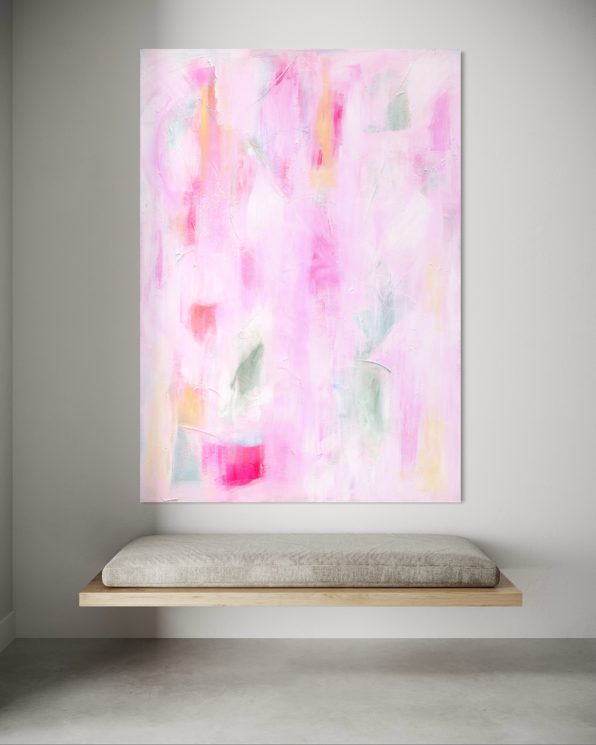 Abstract painting with pink and white strokes on a gray wall above a floating wooden shelf.